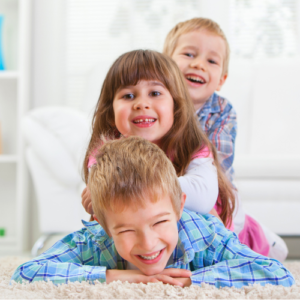 Smiling children with an activity book