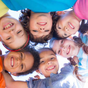 A group of smiling children with activity books for all ages